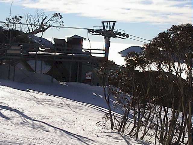 Top station of Snow Gums chair silhouetted against the fog bank over Jindabyne