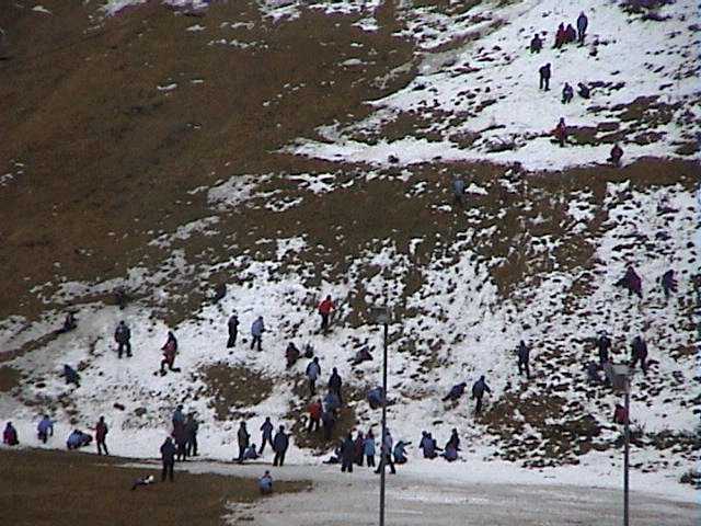 Real snow enthusiasts near the tennis courts yesterday in the rain