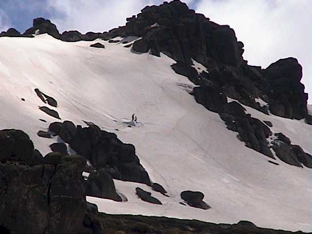 Snow boarders revisiting their jump built on the weekend