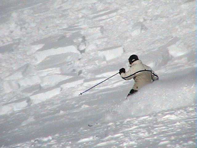 Skier passing by the slide debris