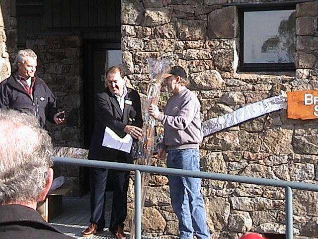 Kim Clifford, General Manager of Kosciusko Thredbo, presenting the club with a set of antique skis