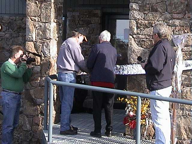 Richard Gallimore and Anne Dudzinski cutting the foil ribbon to open the new Brindabella lodge