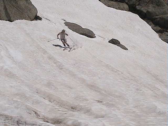 Ray heading for the deep rainwater ruts on the snow pack