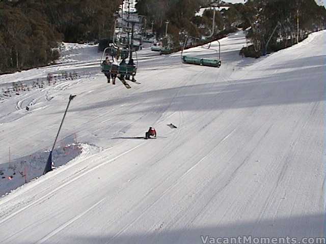 No names mentioned  ski patroller popping a ski under Kosi Express<br>in front of the first 4 chairs of the morning