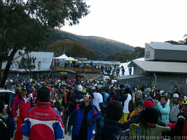 Part of the crowd lining up to carry a flare down the mountain