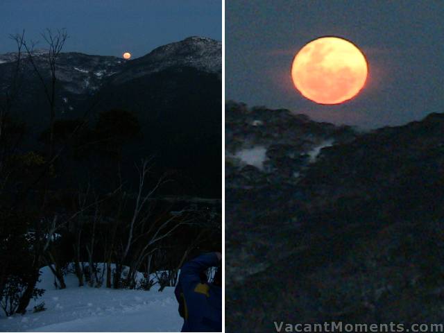 A full moon rising over the village