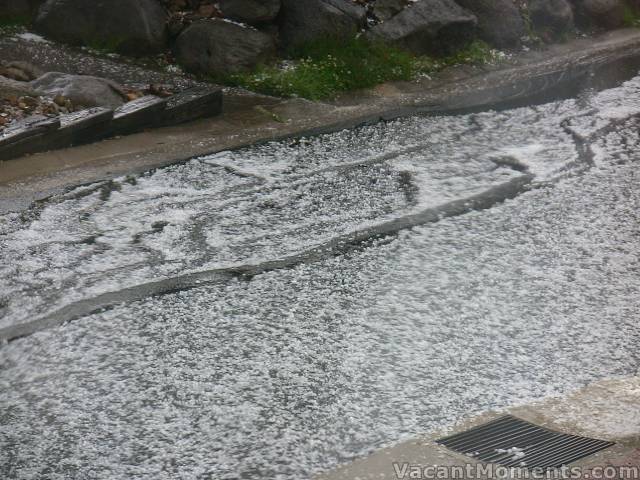 A flood of hail rushing down the streets