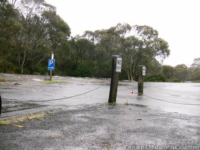 Thredbo River spreading over the road at the parking lot - Village Green