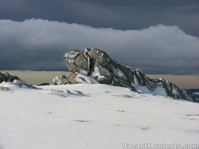 Dramatic contrast of snow against black clouds