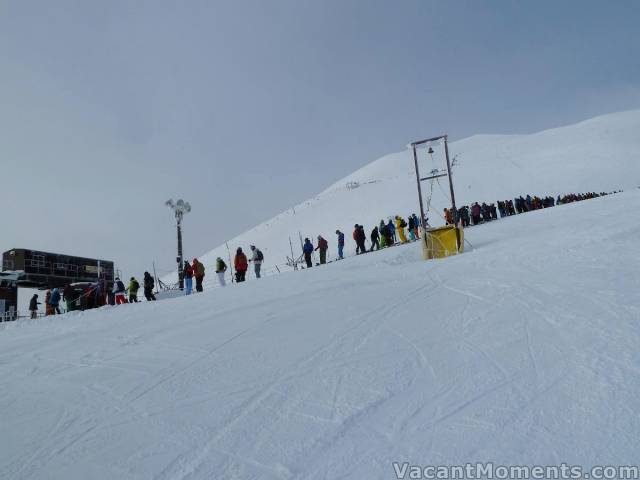 Then at the top lift - this almighty queue - photo courtesy of Rosco<BR>if you look carefully behind the top of the bell tower you'll see the line hiking to the peak