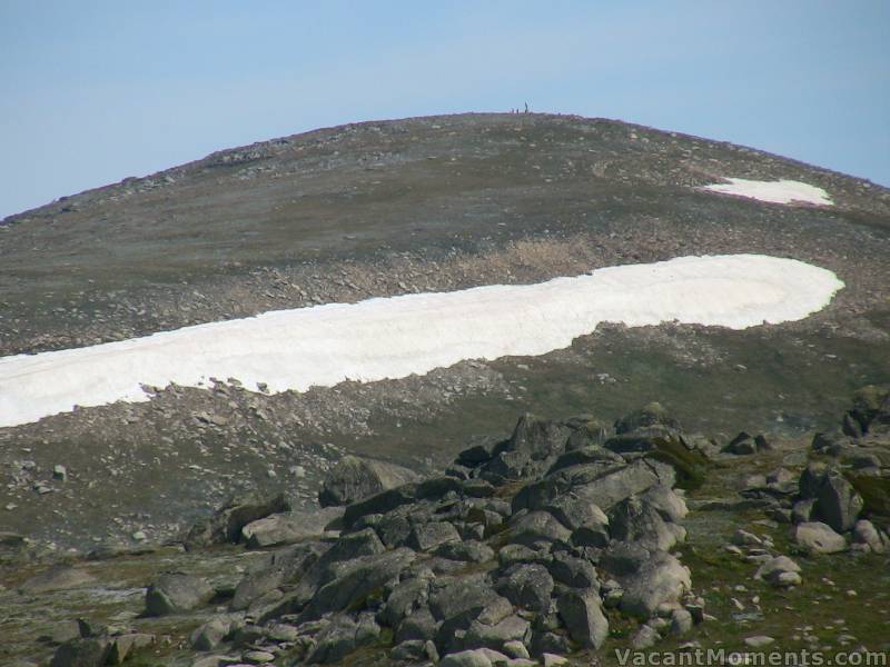 Close up showing someone standing (not recommended) on the rock cairn<BR>the highest point in Australia