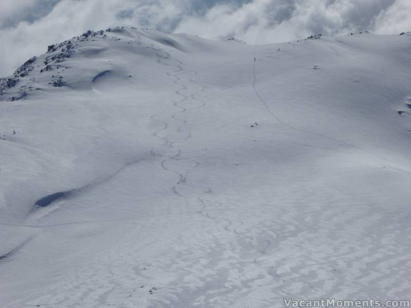 Our tracks down the South Ridge and a loner climbing to the top