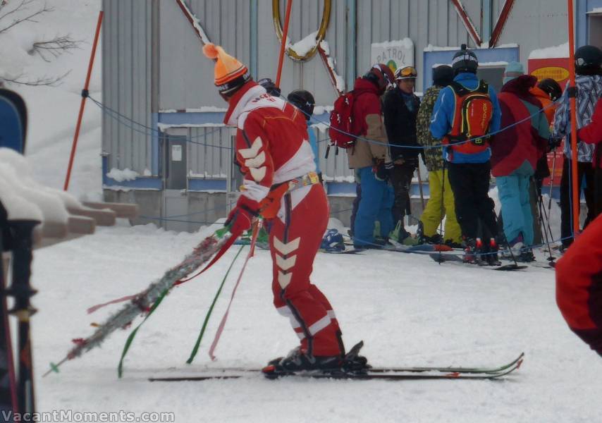 Bindings mounted backwards and skier mounted backwards<BR>Special jacket, belt, bum bag, hat and Christmas decorations