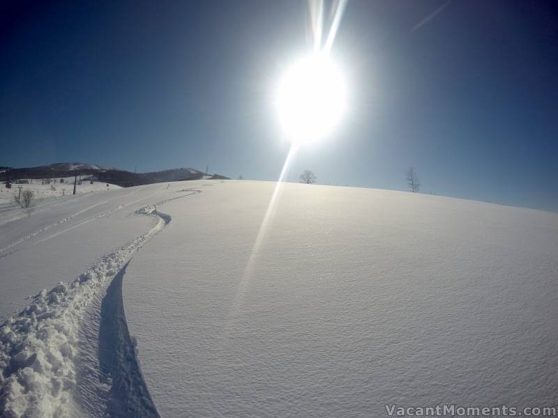 Tracked slopes under a rising sun